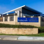 Exterior view of Buttercups Perth Childcare and Early Learning Centre, showcasing a modern, secure facility with clear signage, shaded outdoor play areas, and a welcoming environment designed to support children's growth and development.