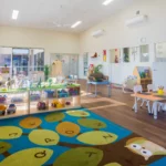 Bright and engaging indoor learning space at Buttercups Perth Childcare, featuring interactive play areas, educational resources, and cosy seating, designed to foster creativity, exploration, and early development in a nurturing environment.