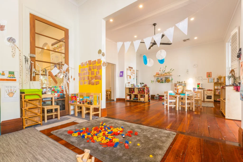 Bright and engaging indoor learning space at a Perth childcare centre, featuring activity stations, creative decorations, and educational resources for children.