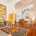 Bright and engaging indoor learning space at a Perth childcare centre, featuring activity stations, creative decorations, and educational resources for children.