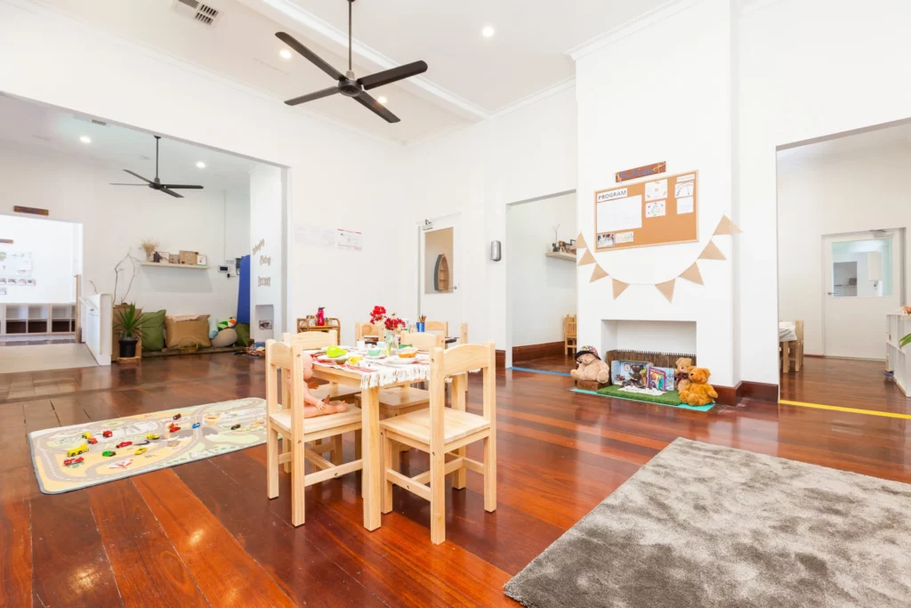 Inviting indoor activity space at a Perth childcare centre, featuring a play table, educational resources, and cosy areas for learning and creativity.