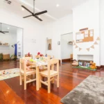 Inviting indoor activity space at a Perth childcare centre, featuring a play table, educational resources, and cosy areas for learning and creativity.