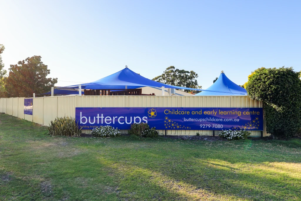 Exterior view of Buttercups Perth Childcare and Early Learning Centre, featuring a vibrant sign with the logo, contact details and tagline.