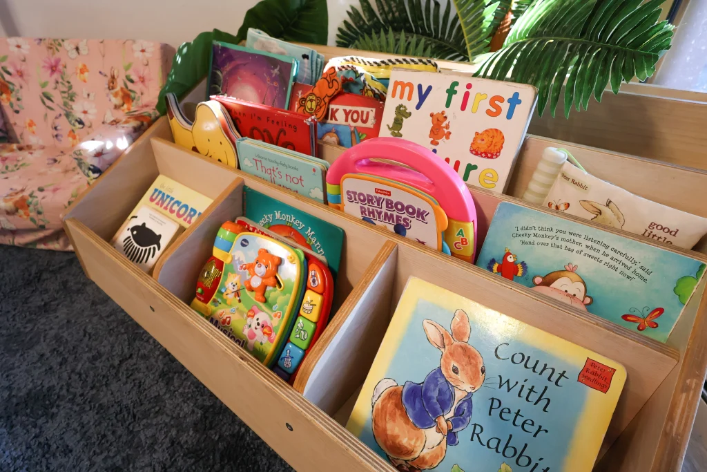 A cozy reading corner at Buttercups Childcare with child-friendly furniture, a variety of engaging children’s books, and a nurturing atmosphere that fosters creativity and development.