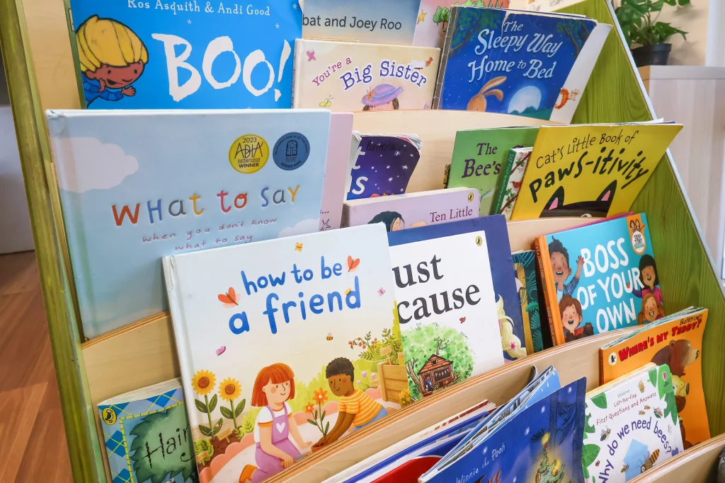 Cosy reading nook at Buttercups Perth Childcare, featuring a beautifully arranged bookshelf filled with colourful children's books, creating an inviting space for early literacy and exploration.