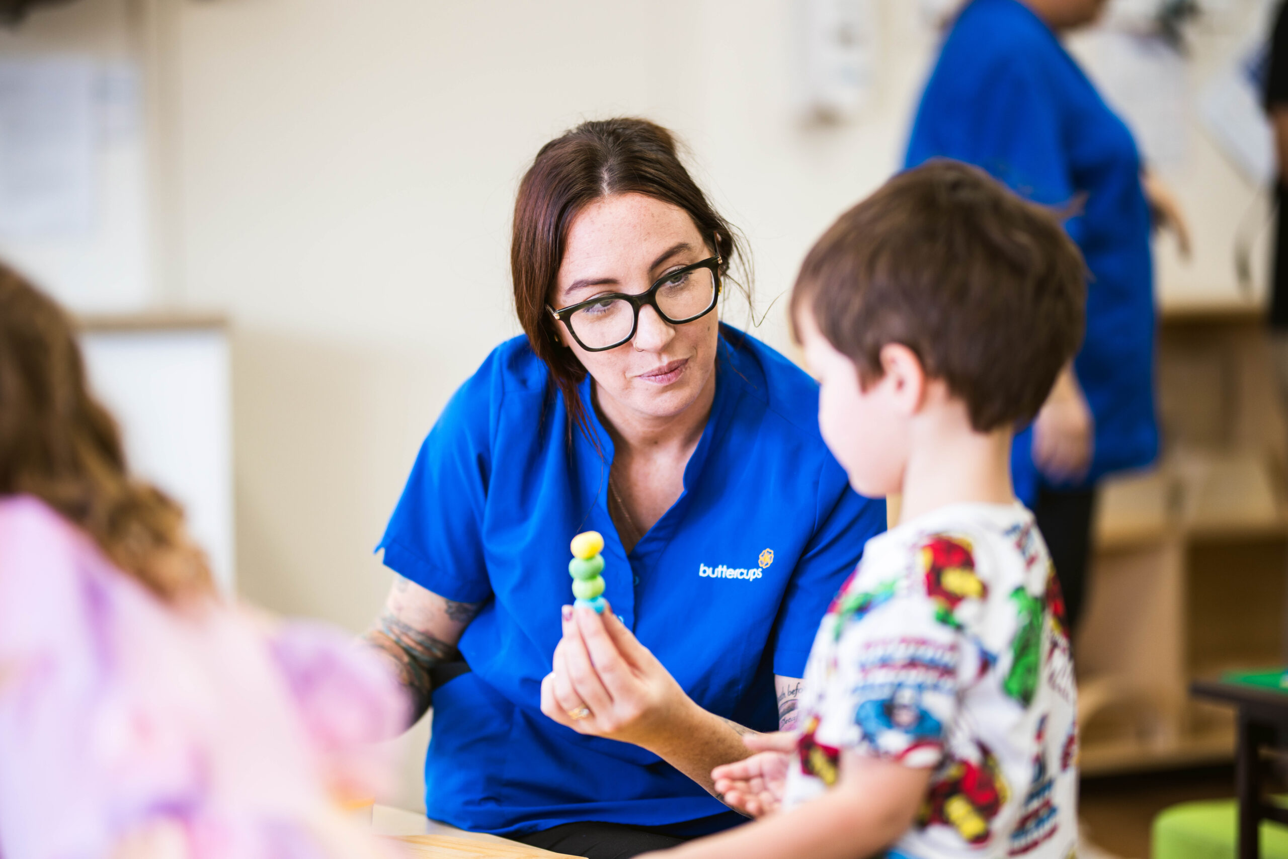 Educator interacting with a child at Buttercups Perth childcare centre, showcasing engaging and hands-on learning activities.