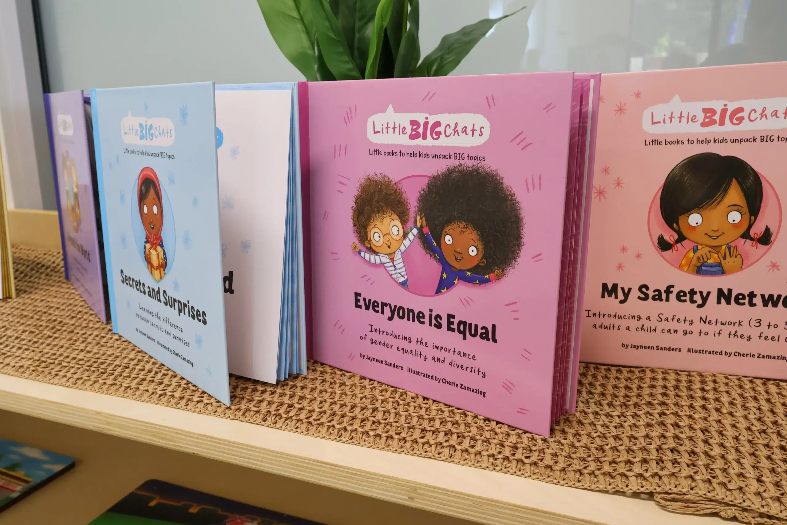 A collection of "Little BIG Chats" children's books on a wooden shelf at Buttercups Perth Childcare. Titles like "Everyone is Equal" and "My Safety Network" introduce kids to topics like equality, diversity, and personal safety, fostering valuable early education in a nurturing environment.