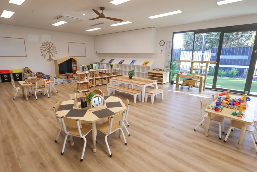 Bright and spacious classroom at Buttercups Perth Childcare, featuring natural wooden furnishings, interactive learning stations, and engaging activity areas designed to foster creativity.