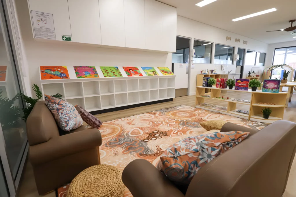 Indoor play area at Buttercups Perth Childcare showcasing a cosy reading nook, filled with a range of colourful books designed to engage children and support their learning and imagination.