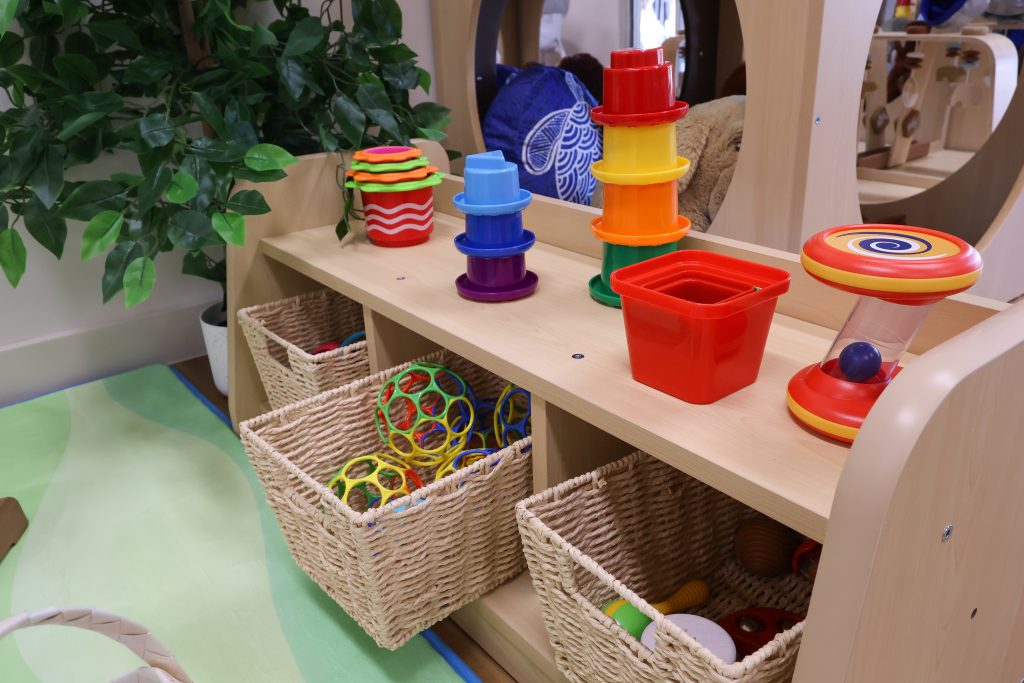 A learning shelf at Buttercups Perth Childcare displays colourful oballs, instruments, and blocks within easy reach. This low-level shelf is designed to encourage hands-on exploration and independent play for the littlest learners.