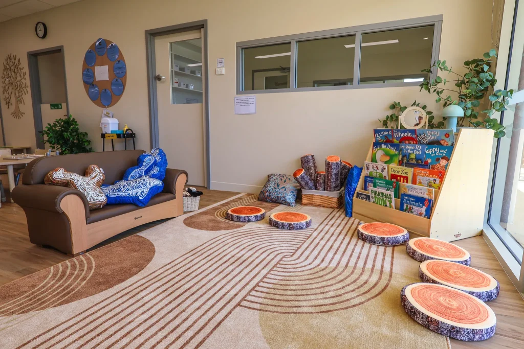 Indoor play area at Buttercups Perth Childcare showcasing a cosy reading nook, filled with a range of colourful books designed to engage children and support their learning and imagination.