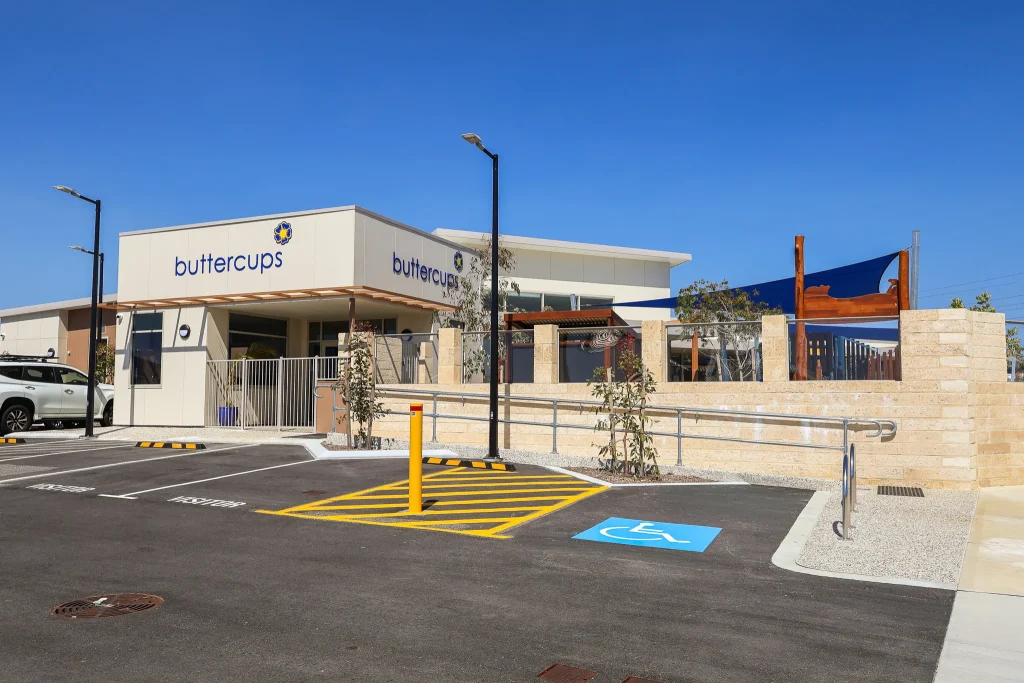 Exterior view of Buttercups Perth Childcare and Early Learning Centre, showcasing a modern, secure facility with clear signage, shaded outdoor play areas, and a welcoming environment designed to support children's growth and development.