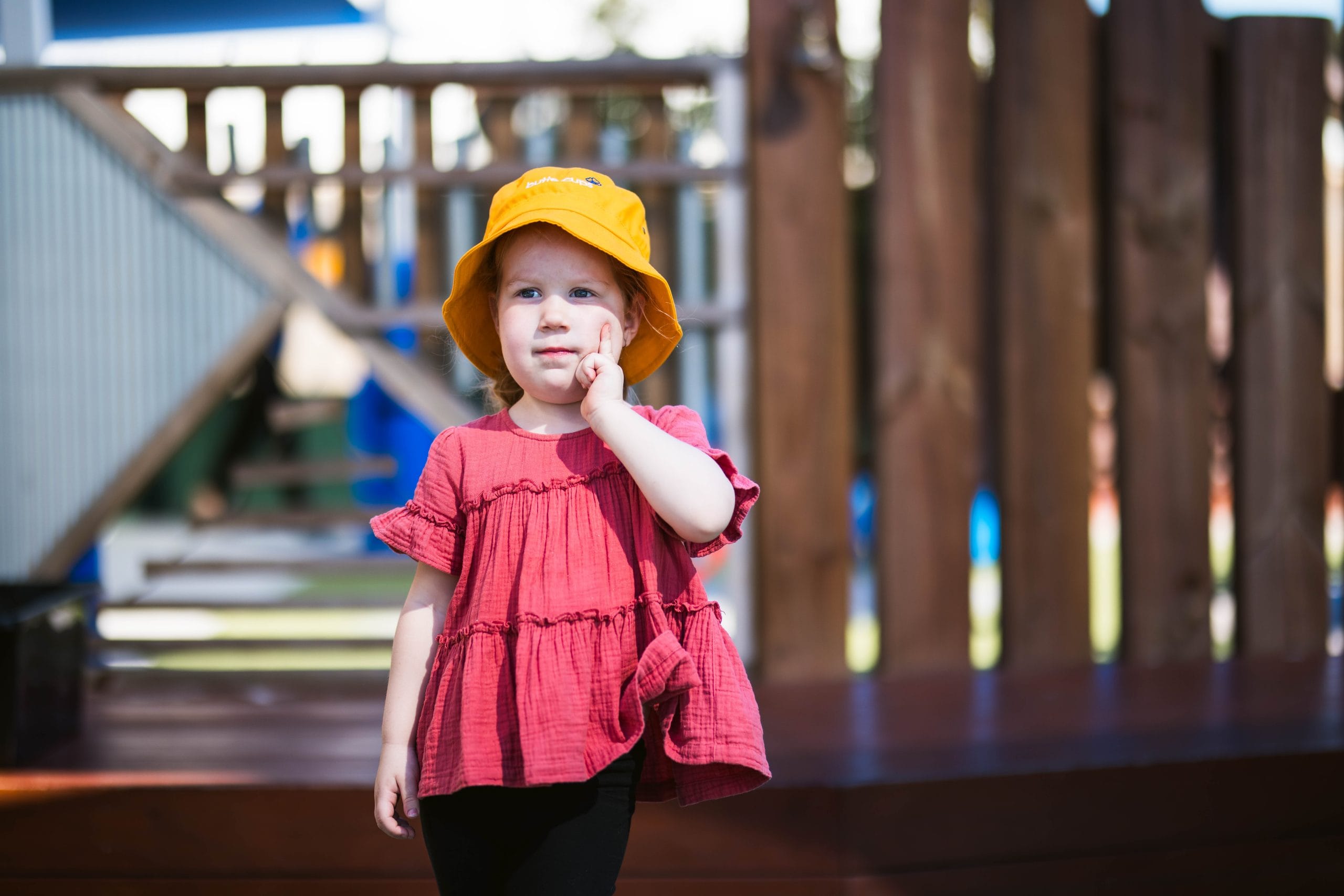 A young child at Buttercups Childcare in Perth pauses with a “thinking face” as families explore the new 3 Day Guarantee for childcare.