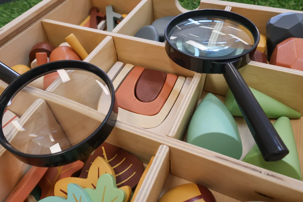 Exploration activity at Buttercups Perth Childcare, featuring magnifying glasses and blocks in different shapes and sizes, designed to spark curiosity and hands-on learning.